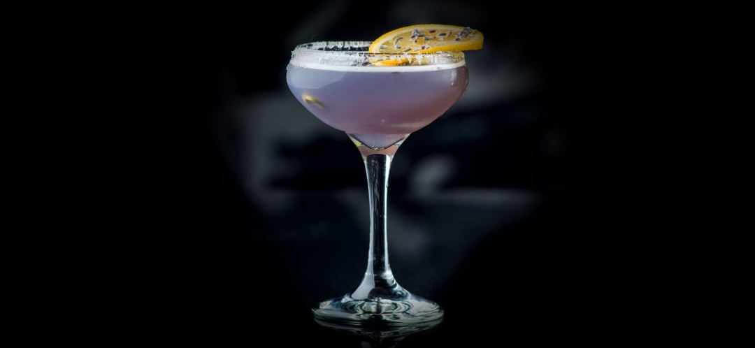 Lavender Lemon Drop cocktail from the Lucy's Lounge menu, with a dried lemon wheel